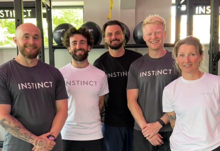 Five, friendly head coaches/person trainers with big smiles in the main gym area at Instinct Gym in Tarporley.